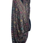 A richly patterned Kani semi-pashmina shawl draped on a black mannequin, featuring intricate floral and paisley designs in vibrant multi-colors on a dark background.