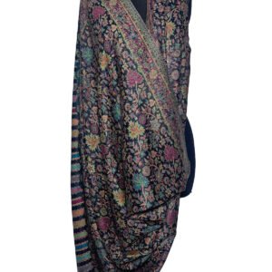 A richly patterned Kani semi-pashmina shawl draped on a black mannequin, featuring intricate floral and paisley designs in vibrant multi-colors on a dark background.