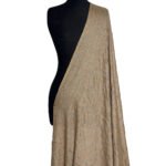 A full view of a light beige or sand-colored semi-pashmina shawl draped elegantly on a black mannequin, featuring subtle, light-colored floral and swirling "jaal" embroidery patterns.