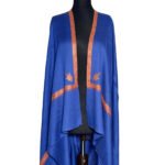 Luxurious sapphire blue semi-pashmina shawl with intricate burnt orange or rust-colored embroidery along the edges and in leaf motifs, elegantly draped on a black mannequin.